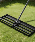 Wide 30 Inch Lawn Leveling Rake With Adjustable 47 To 77 Inch Telescoping Handle And 180 Degree Rotating Head in use on grass