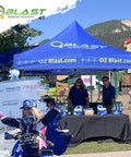Outdoor event booth displaying 99.99 Percent Pure Oxygen On The Go Can With Mask, with staff and promotional setup.