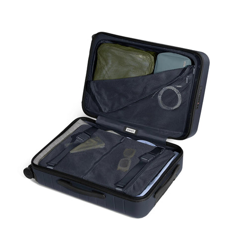 Open view of Bigger Carry On Luggage From Away, navy blue with ample interior, lightweight hardside large suitcase with organizational compartments