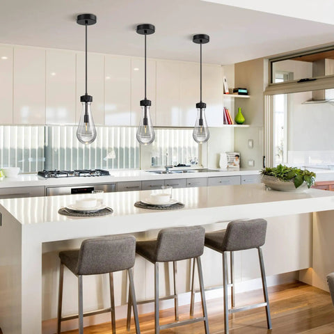 Modern kitchen with gray bar stools and pendant lights above island, featuring a sleek, minimalist design.