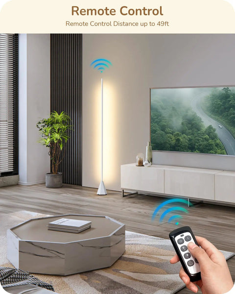Modern living room with remote controlled tall floor lamp beside a TV and plant, emphasizing remote control feature.