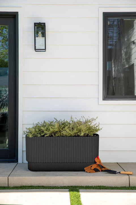 Long Planter For Porch Patio And Backyard In Durable Plastic Stone Composite Fluted All Weather Outdoor Pot For Shrubs And Flowers Modern Decor With Scratch And UV Resistant Finish on a porch