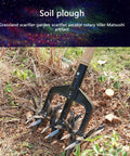 Manual Garden Cultivator With Interchangeable Handheld Scarifier And Handle Attachment used on soil in a grassy area