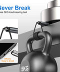 5kg black kettlebell with braided black USB-C to USB-A charging cable looped around its handle in a load test