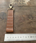 Vintage Tan Leather Golf Tee Holder For 5 Tees With Snap Hook Hand Stitched Cow Leather Retro Style Golf Accessory next to ruler