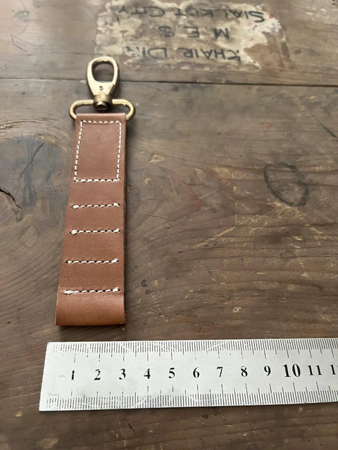 Vintage Tan Leather Golf Tee Holder For 5 Tees With Snap Hook Hand Stitched Cow Leather Retro Style Golf Accessory next to ruler