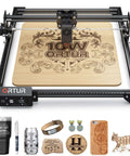 Front view of ORTUR Laser Master 2 S2 LU2-10A laser engraver with a black frame engraving a wooden board with an ornate design.