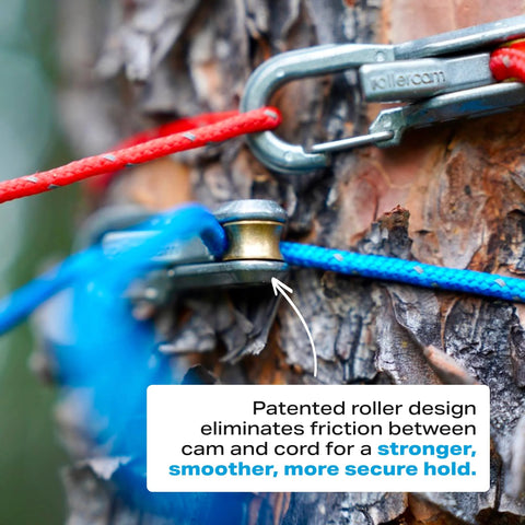 Roperoller rope tensioner with Rollercam design; blue and red cords secured to a tree outdoors
