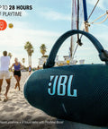 Charge 6 Portable Waterproof Bluetooth Speaker With AI Sound Boost hanging on a net with beach scene in background.