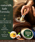 Applying Heavy Duty Furniture Salve For Wood And Leather Polish Conditioner on leather couch with brush for restoration.