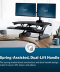 Cube Corner 36 Inch Standing Desk Converter for dual monitors with spring lift, adjustable height, black, in home office setup.