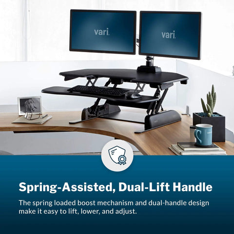 Cube Corner 36 Inch Standing Desk Converter for dual monitors with spring lift, adjustable height, black, in home office setup.