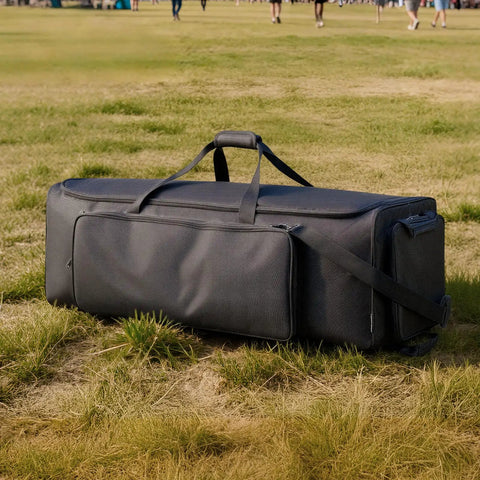 Rock Solid Drum Hardware Rolling Bag With Smooth Gliding Wheels And Extra Thick Padding For Snare Cymbal Stands And Kick Drum Pedals legit heavy duty music gear hauler in black resting on grass.