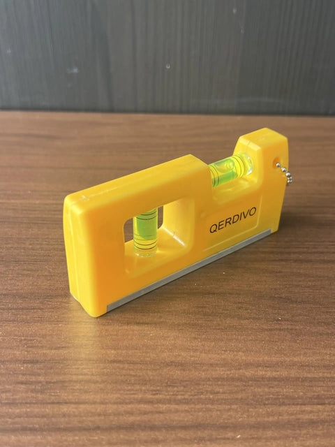 QERDIVO Spirit Levels Mini Horizontal Vertical Pockets Spirit Levels Spirit Bubble Leveler in bright yellow design on wood surface.