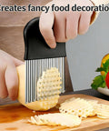 French fry slicer with black handle and stainless steel blades cutting a potato on a cutting board