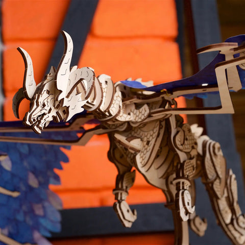 Windstorm Dragon Model Kit 3D Mechanical Puzzle With Rubber Band Motor For Adults To Build Fun Brain Teaser Hobby Kit That Lets The Wings And Body Animate In Realistic Flight Motion. close-up of white and blue wooden dragon model