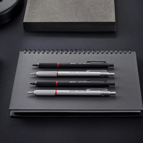 Pro Grade 0.5mm Mechanical Pencil With Brass Mechanism Cushioned Lead Built In Eraser Knurled Non Slip Grip Matte Black Finish A True Workhorse For Crisp Lines Precision Writing And Sketching, shown on notebook