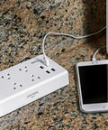Eight International Adapters Travel Charging Station With Surge Protector And Four Smart USB Ports on granite surface