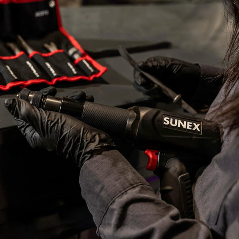 Person holding Long Barrel Air Hammer For Heavy Duty Demolition And Workshop Use, 2300 Blows Per Minute, 3.75 Inch Stroke, 0.401 Inch Universal Chuck Included, Rugged CR-MO Steel Build With Ball Detent For Socket Retention