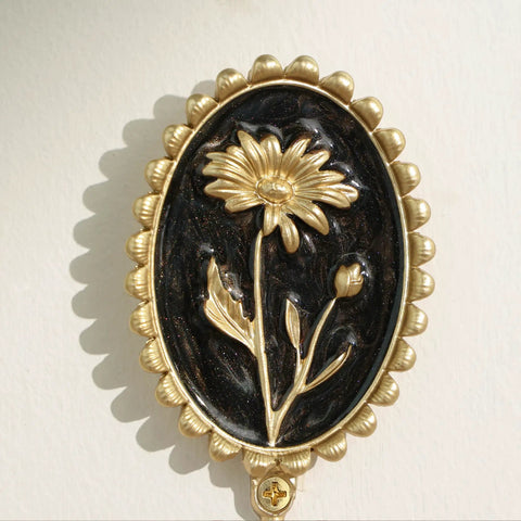 Super Clean Set Of Three Straight Up Vintage Wall Hooks With French Garden Floral Details and classic scalloped metallic hardware close-up