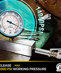 Front view of Saker grease gun coupler with 1/8 in NPT fitting and inline pressure gauge up to 14,000 psi