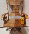 Antique wooden chair with Orange Oil Wood Polish And Cleaner For Furniture And Teak 2 Step Wood Care Kit bottle on seat.