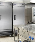 Go Big Commercial Reach In Freezer With 23 Cubic Feet Of Beefy Storage Straight Up Frost Free Operation And Rugged Stainless Steel Cabinet in a kitchen.