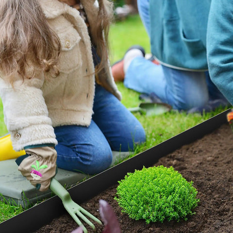 Child gardening with 10 Pack Galvanized Steel Landscape Edging 4.5 Inch High Black Powder Coated Bendable Hammer In Border