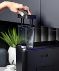 Game Changer Automatic Espresso Machine Packing Built In Milk Frother showing removable water container in glossy black finish.