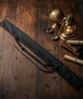 Katana Sword Bag With Strap Black Carry Case For Samurai Swords on wooden table with vintage decor