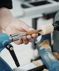 Pen Press Kit For Woodturning Lathes With 2MT Taper showcasing precise nib alignment on lathe with wood and tool in use