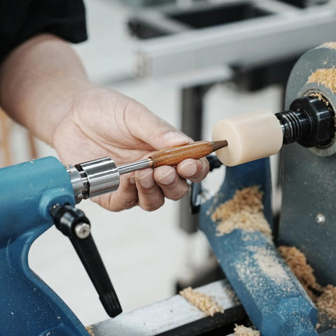 Pen Press Kit For Woodturning Lathes With 2MT Taper showcasing precise nib alignment on lathe with wood and tool in use