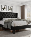 Queen Size Platform Bed Frame With Button Tufted Wingback Headboard, Black Upholstered Bedroom Staple, solid wood slats, unmade bed with gray blanket.