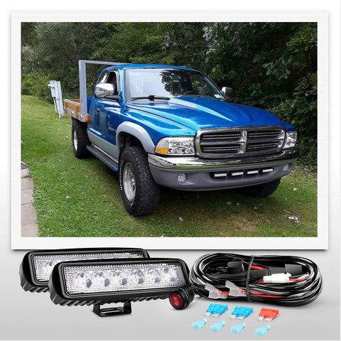 Two Pack 18W Spot LED Work Lights For Off Road Driving Fog Beams with truck and 16 AWG Wiring Harness Kit visible