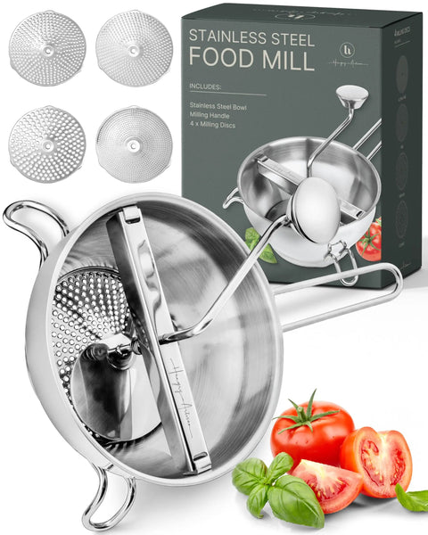 4 Disc Stainless Steel Food Mill With Ergonomic Hand Crank For Tomato Sauce Canning Applesauce Baby Food Mashed Potatoes Puree And Jams A Pro Grade All In One Kitchen Tool For Precise Texture Control And Smooth Results; food mill with 4 discs and hand crank shown near tomatoes and basil with packaging box in background.