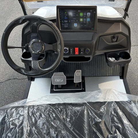 Interior view of Six Seater Electric Leisure Cart With Premium Upholstered Interior And Beefy All Terrain Tires showing dashboard, pedals, and controls.