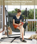 Woman reading on 360 Degree Swivel Hammock Swing Chair With Stand Cushioned Hanging Chair for indoor and outdoor use on porch.