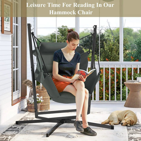 Woman reading on 360 Degree Swivel Hammock Swing Chair With Stand Cushioned Hanging Chair for indoor and outdoor use on porch.