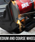 Heavy Duty Eight Inch Bench Grinder Equipped With A Kickass Three Point Zero Amp Motor And Bright Led Work Light Paired With Nifty Water Cooling Tray For Effortless Metal Sharpening Tasks showing close-up of medium and coarse grinding wheels with sparks.