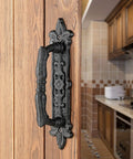 4 Pack Heavy Duty 8.9 Inch Black Cast Iron Barn Door Handles Set mounted on wooden door in rustic kitchen setting