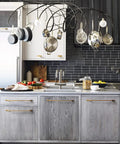 Modern kitchen with Six Pack Antique Brass Cabinet Pulls Zinc Alloy Dresser Handles on gray cabinets under pot rack.