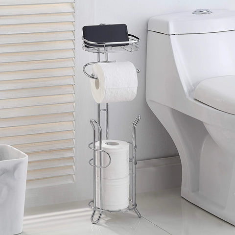 Free Standing Chrome Toilet Paper Holder With Reserve Shelf And Storage Basket next to toilet, holding three mega rolls