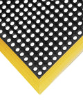 Safety Stance 40 By 40 Inch Anti Fatigue Drainage Mat With Four Sided Black Yellow Border Thick Seven Eighths Inch Oil And Chemical Resistant Rubber Large Hole Drainage Diamond Stud Top Surface For Non Slip Grip corner close-up