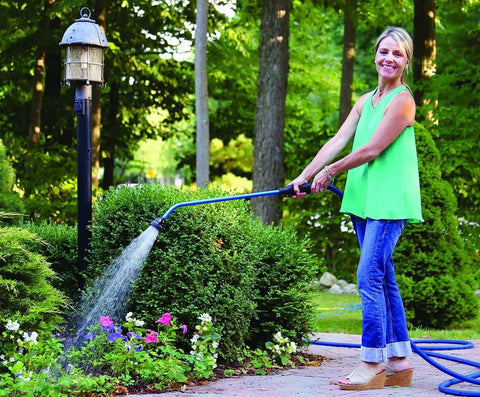 Woman using Kaleidoscope Rain Wand 16-Inch Touch-N-Flow With Trigger Shut-Off Valve And Lock for garden watering