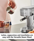 Premium Metal Semi Automatic Espresso Machine With Dual Smart Temp Sensors And 58Mm Commercial Portafilter pouring milk into coffee glass.