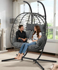 Two Person Foldable Hanging Egg Chair With Stand For Indoor Outdoor Use Wicker Porch Swing Chair Heavy Duty Rattan Hammock Loveseat With Cushions For Bedroom Garden Balcony Patio 650 Lbs Cozy Vibes indoors with couple and cat.
