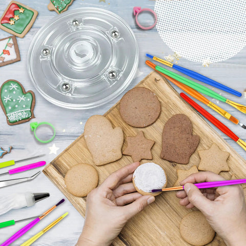 Top Tier Knockout 56 Piece Cookie Decorating Kit With Solid Acrylic Turntable Non Slip Pad Premium Piping Bags Stainless Icing Tips And Dope Brushes For Sweet Kitchen Creations shown with cookies and brushes.