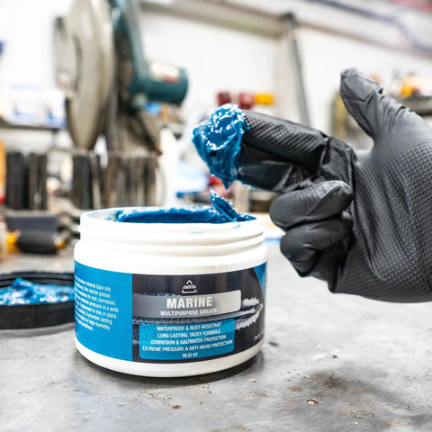 Gloved hand using Go-To Premium Mineral Base Marine Grease With Water-Resistant Formula, Heavy-Duty Lubricant, 16 oz tub