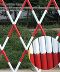 Hardened Steel Expanding Safety Barricade Hella Visible Traffic Barrier With Slick Rolling Casters Top Shelf Folding Pedestrian Gate For Driveways And Worksites Solid Red White Color Block Design detailed view of red and white retractable fence structure with grass background.