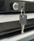 Close-up of the central cam lock with keys on the Beefy Two Drawer Portable Metal Tool Chest Cabinet With Ball Bearing Drawer Slides And 26 Inch Steel Storage Box Organizer Non Slip Drawer Liners Black.